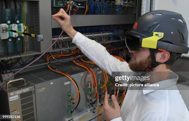 Moritz Quandt, research assistant at the Institut für Produktion und Logistik GmbH at the University of Bremen wearing data glasses while...