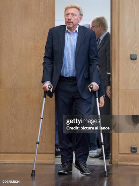 German former professional tennis player Boris Becker arriving in crutches to a press conference by the German Tennis Federation at Romerberg in...