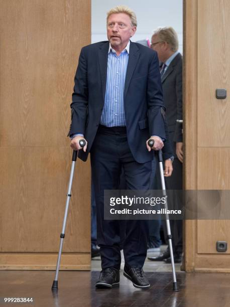 German former professional tennis player Boris Becker arriving in crutches to a press conference by the German Tennis Federation at Romerberg in...