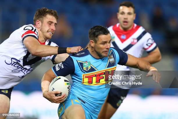 Michael Gordon of the Titans is tackled during the round 18 NRL match between the Gold Coast Titans and the Sydney Roosters at Cbus Super Stadium on...