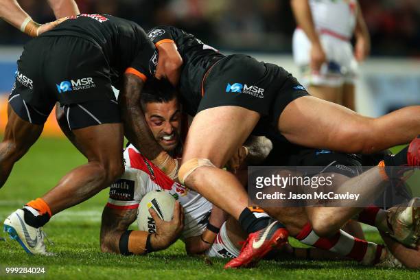 Paul Vaughan of the Dragons is tackled during the round 18 NRL match between the St George Illawarra Dragons and the Wests Tigers at UOW Jubilee Oval...