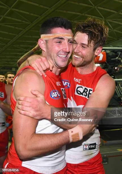 Colin O'Riordan of the Swans is hugged by Dane Rampe after winning the round 17 AFL match between the North Melbourne Kangaroos and the Sydney Swans...