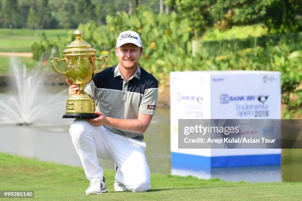 Justin Harding of South Africa pose with the trophy after winning the Bank BRI Indonesia Open at Pondok Indah Golf Course on July 15, 2018 in...