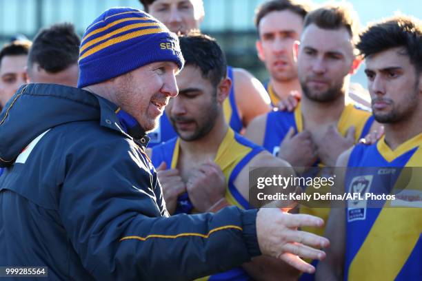 Andrew Collins senior coach of the Seagulls speaks to players during the round 15 VFL match between the Northern Blues and Williamstown Seagulls at...