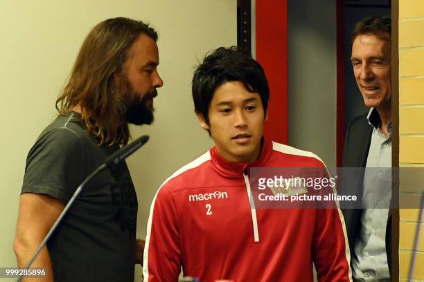 Press spokesman Arbeit , Japanese soccer player Atsuto Uchida and Helmut Schulte, head of the licensing department, arriving to Uchida's introduction...