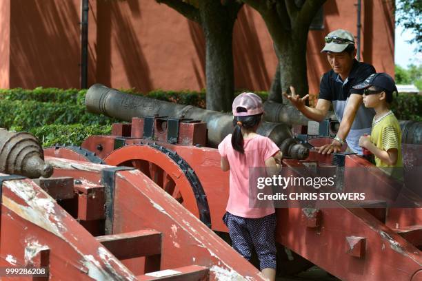 Father explains how a cannon works to his children as they tour the grounds of Fort San Domingo, originally established in 1628 by the Spanish, in...