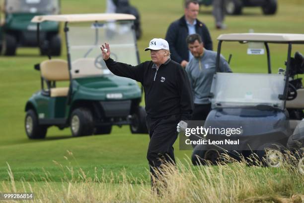 President Donald Trump waves whilst playing a round of golf at Trump Turnberry Luxury Collection Resort during the U.S. President's first official...