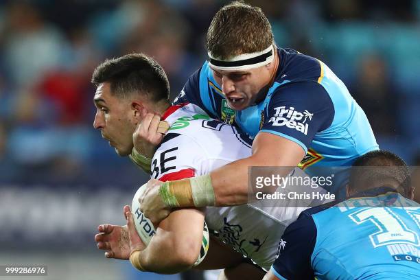 Kane Elgey of the Roosters is tackled by Jarrod Wallace of the Titans during the round 18 NRL match between the Gold Coast Titans and the Sydney...