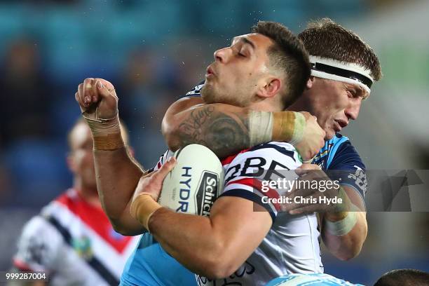 Kane Elgey of the Roosters is tackled by Jarrod Wallace of the Titans during the round 18 NRL match between the Gold Coast Titans and the Sydney...