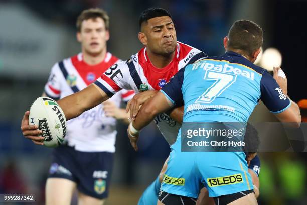 Daniel Tupou of the Roosters passes while tackled during the round 18 NRL match between the Gold Coast Titans and the Sydney Roosters at Cbus Super...