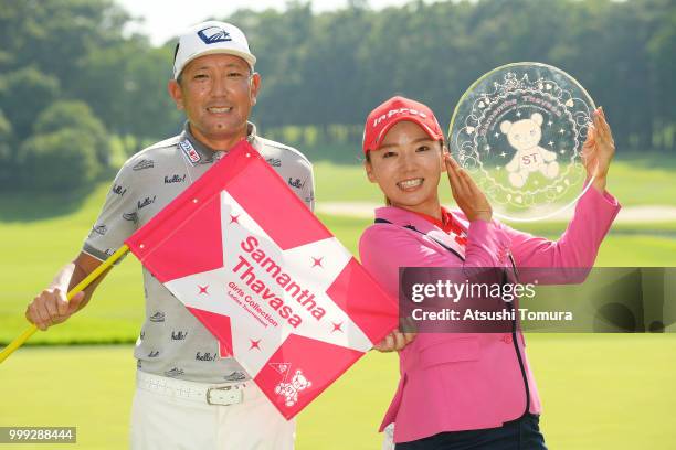 Chie Arimura of Japan poses with her caddie after winning the Samantha Thavasa Girls Collection Ladies Tournament at the Eagle Point Golf Club on...