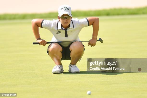 Hee-Kyung Bae of South Korea lines up her putt on the 18th hole during the final round of the Samantha Thavasa Girls Collection Ladies Tournament at...