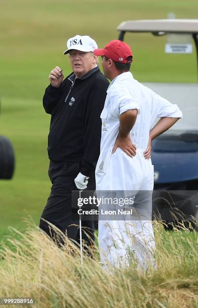 President Donald Trump chats with a Caddie whilst playing a round of golf at Trump Turnberry Luxury Collection Resort during the U.S. President's...