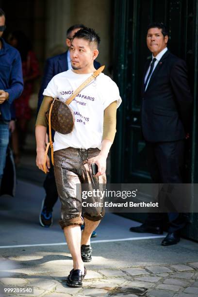 Guest wears a shoulder strapped Vuitton bag, outside Dior, during Paris Fashion Week - Menswear Spring-Summer 2019, on June 23, 2018 in Paris, France.