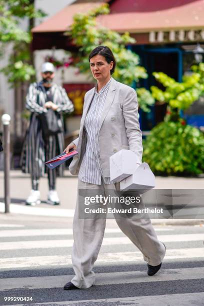 Anastasia Barbieri wears a gray blazer jacket, flared pants, outside Wooyoungmi, during Paris Fashion Week - Menswear Spring-Summer 2019, on June 23,...