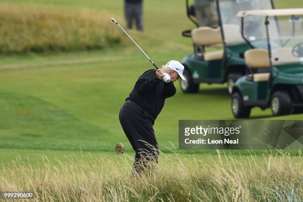 President Donald Trump hits a tee shot whilst playing a round of golf at Trump Turnberry Luxury Collection Resortduring the U.S. President's first...