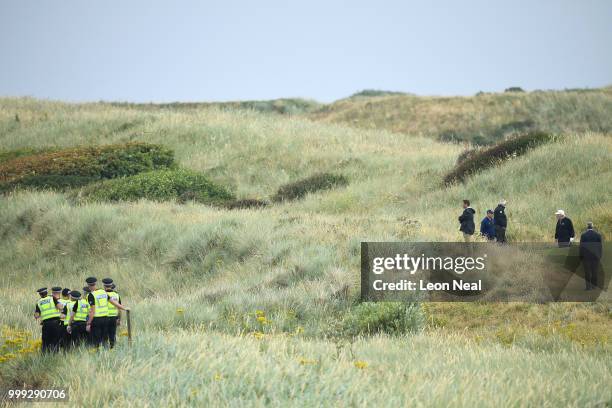 Police officers stand guard whilst U.S. President Donald Trump plays a round of golf at Trump Turnberry Luxury Collection Resort during the U.S....