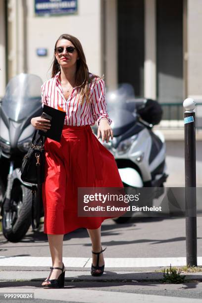 Guest wears a red and white striped shirt, a red skirt, outside Wooyoungmi, during Paris Fashion Week - Menswear Spring-Summer 2019, on June 23, 2018...