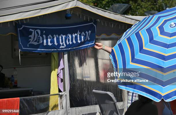 Banner reads "Biergarten" at a camping site at Forggensee lake near Dietringen, Germany, 23 August 2017. Photo: Karl-Josef Hildenbrand/dpa