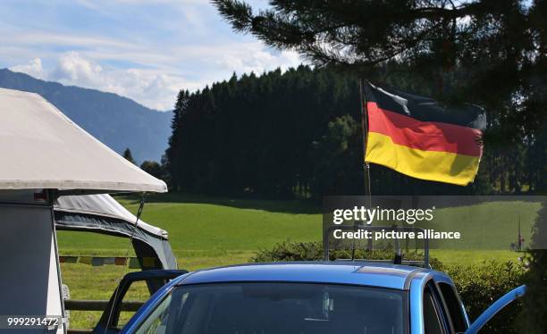 German flag at a camping site at Forggensee lake near Schwangau, Germany, 23 August 2017. Photo: Karl-Josef Hildenbrand/dpa