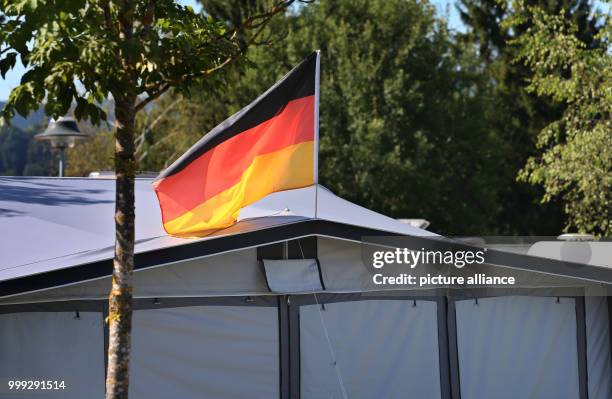 German flag on a tent at a camping site at Forggensee lake near Schwangau, Germany, 23 August 2017. Photo: Karl-Josef Hildenbrand/dpa