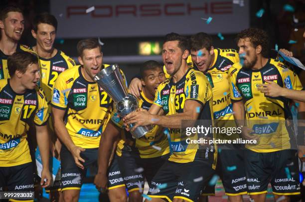 The Rhein-Neckar Loewen team celebrate their win in the DHB-Supercup handball match between Rhein-Neckar Loewen and THW Kiel at the Porsche-Arena in...