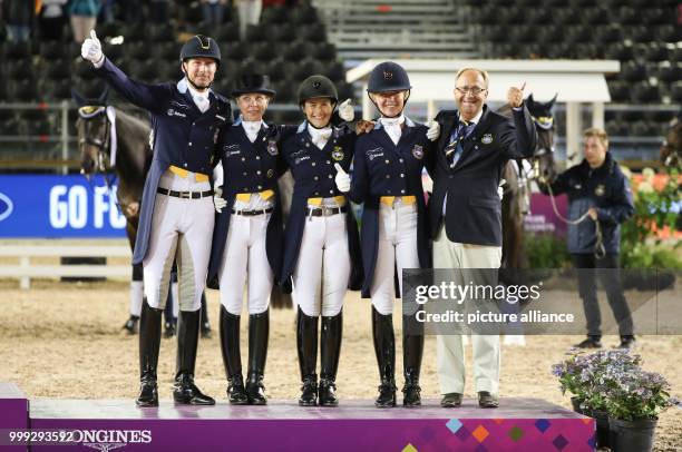 The Swedish dressage riders Patrik Kittel , Therese Nilshagen, Tinne Vilhelmson Silfven, Rose Mathisen and team coach Bo Jena celebrating their...