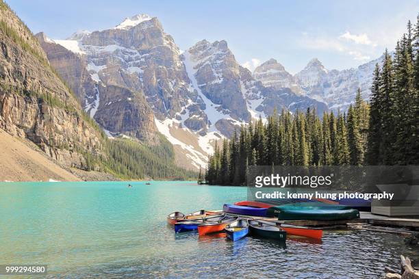 colorful canoes at moraine lake - kenni stock pictures, royalty-free photos & images