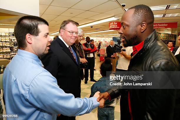 Charles Moore, Steve Offett and Wyclef Jean attend a charity shopping spree at Kmart on May 18, 2010 in New York City.