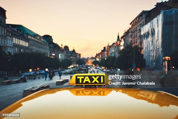 taxi car on the city street - taxi sign stock pictures, royalty-free photos & images