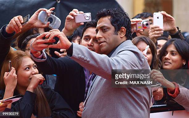 Indian film director Anurag Basu takes a picture with his fans poses as he arrives at the European Premiere of his latest film 'Kites' directed by...