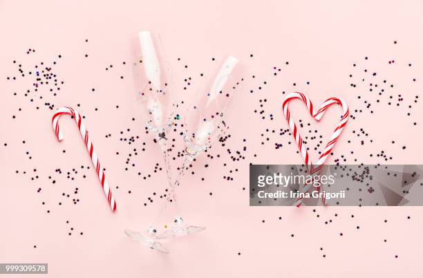 two champagne glasses and candy cane  isolated on an empty pink - overijssel stock pictures, royalty-free photos & images