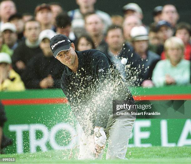 Retief Goosen of South Africa splashes a shot out of the bunker on the last hole during the Lancome Trophy French Open at the St-Nom-la-Breteche Golf...