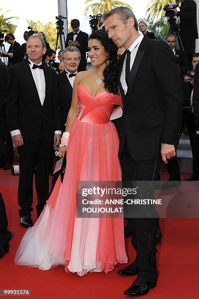 French actor Lambert Wilson and French actress Sabrina Ouazani arrive for the screening of "Des Hommes et des Dieux" presented in competition at the...