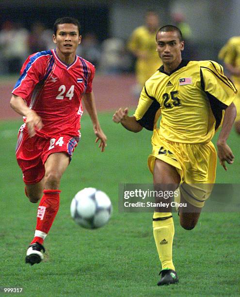 Muhamad Kaironnisam of Malaysia is pursued by Manit Noyvach of Thailand during the Final held at the Shah Alam Stadium, Shah Alam, Selangor, Malaysia...