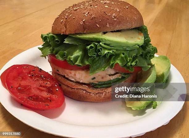 a turkey burger with avocado on a bun - turkey burger stock pictures, royalty-free photos & images