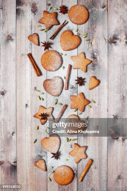 traditional ginger cookies and spices on the wooden table - alina stockfoto's en -beelden