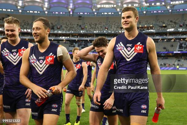 Cam McCarthy, Cameron Sutcliffe, Lachie Neale and Sean Darcy of the Dockers walk from the field after winning the round 17 AFL match between the...