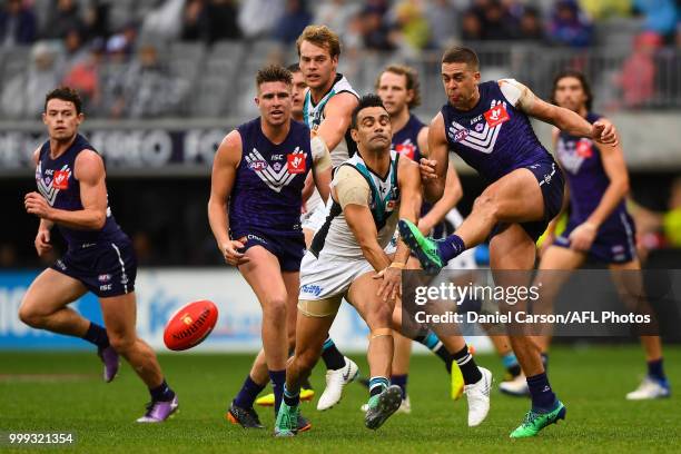 Stephen Hill of the Dockers kicks the ball under pressure from Lindsay Thomas of the Power during the 2018 AFL round 17 match between the Fremantle...