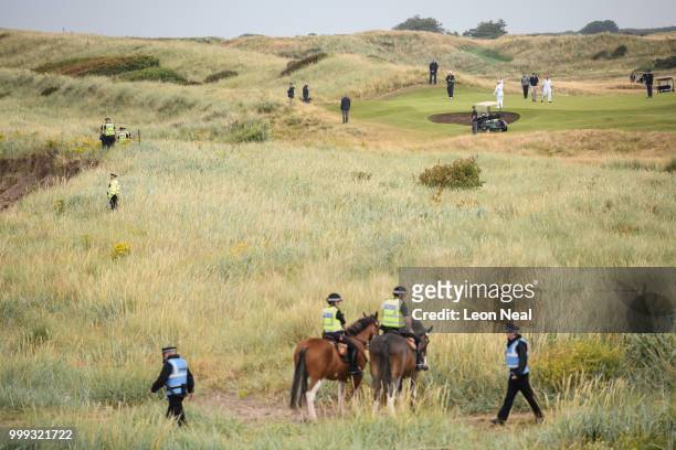 Police and security services surround the perimeter as President Donald Trump plays a round of golf at Trump Turnberry Luxury Collection Resort...