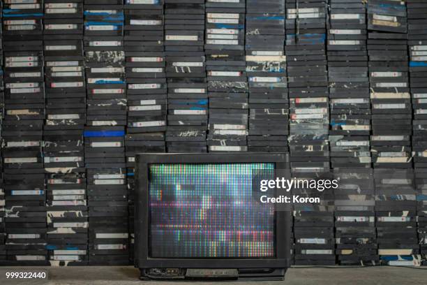 old tv and a pile of tapes - ビデオカセット ストックフォトと画像