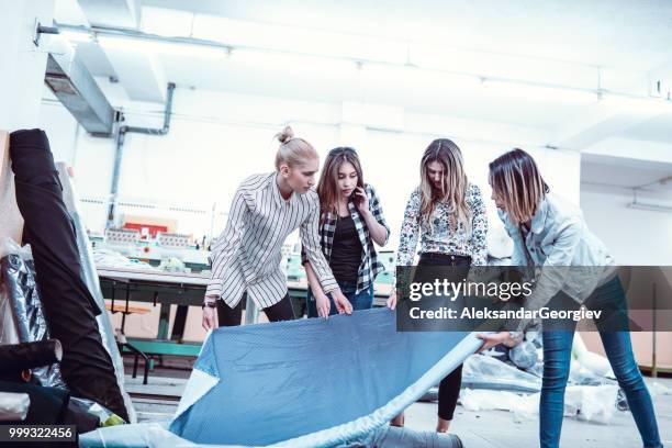 textile factory workers testing and inspecting new material - aleksandar georgiev stock pictures, royalty-free photos & images