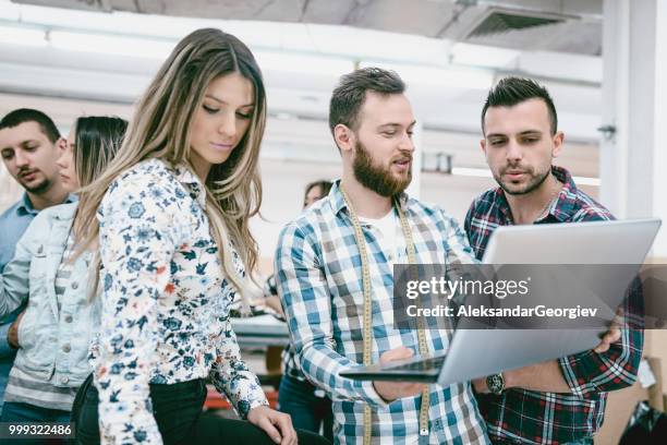 chief designer showing new project to assistant tailors - aleksandar georgiev stock pictures, royalty-free photos & images