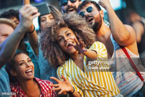 friends snapping selfies. - gilaxia stock pictures, royalty-free photos & images