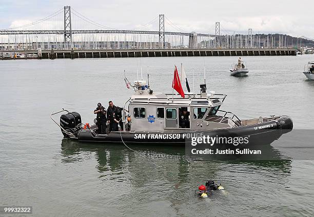 San Francisco police officers pull in suspected terrorist divers after they were cuffed by a trained U.S. Navy seal during a drill that is part of...