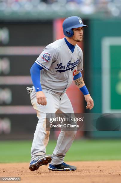 Yasmani Grandal of the Los Angeles Dodgers takes a lead off of second base against the Washington Nationals at Nationals Park on May 19, 2018 in...