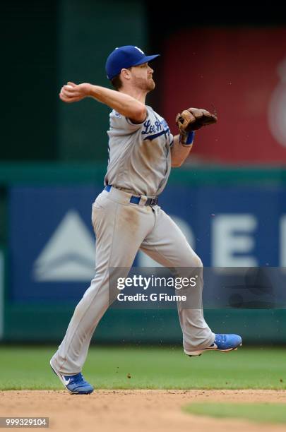 Logan Forsythe of the Los Angeles Dodgers throws the ball to first base against the Washington Nationals at Nationals Park on May 19, 2018 in...