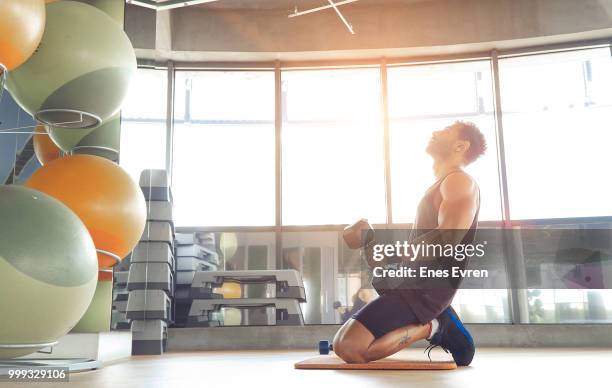 istruttore di fitness in posa in un centro benessere con manubrio - adone foto e immagini stock