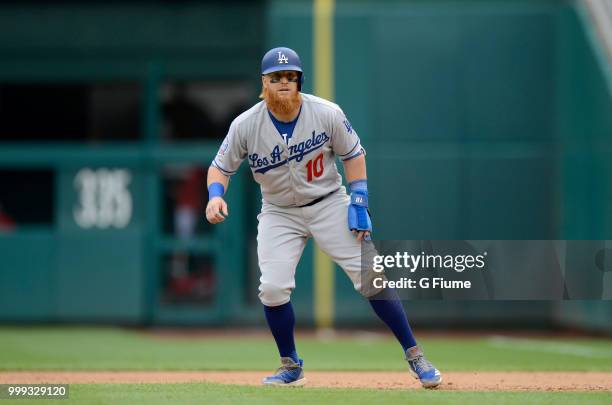 Justin Turner of the Los Angeles Dodgers takes a lead off of first base against the Washington Nationals at Nationals Park on May 19, 2018 in...
