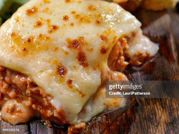 cheesy, beef and veal lasagna - serving lasagna stock pictures, royalty-free photos & images